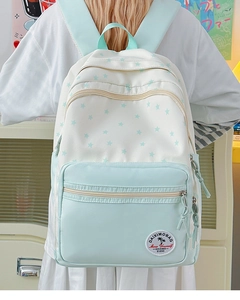Detail of mint green campus backpack with star print and woven zipper pulls