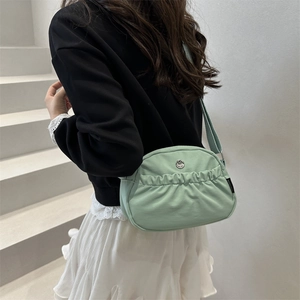 Mint green pleated nylon crossbody bag with adjustable wide strap for urban casual style