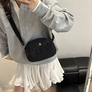 Fashionable black nylon crossbody bag with pleated detail and metal M logo for women