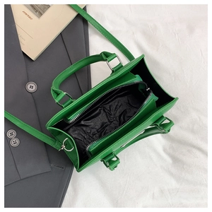 Top view of green Boston bag showing inner lining and center zipper pocket compartment