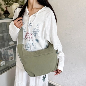 Minimalist olive green nylon crescent crossbody bag with adjustable wide shoulder strap