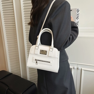 White faux leather Boston handbag for women featuring a sleek zipper pocket and crossbody strap