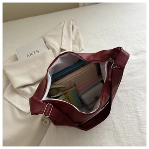 Top view of spacious burgundy tote bag interior showing capacity for umbrella and laptop