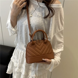 Brown quilted crossbody shell bag with stylish stripes and top handle for summer 2025 fashion