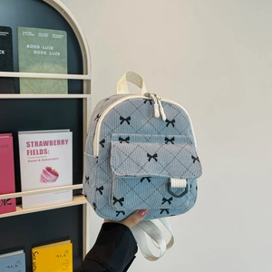 Mini light blue corduroy backpack with diamond stitching and black bow pattern
