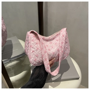 Detailed view of pink pleated shoulder bag with cute bow pattern and zipper closure