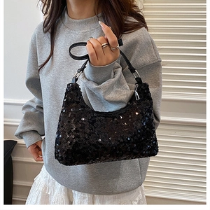 Detailed close-up of high-density black sequins and silver metal rings on luxury bag