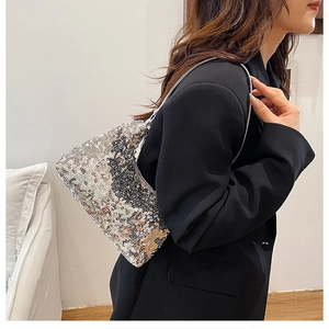 Close-up of sparkling silver and grey sequins on a stylish crescent underarm bag
