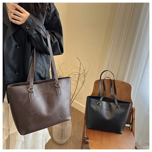 Detailed view of large capacity vintage leather tote bags in brown and black colors