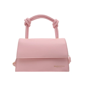 Pink faux leather trapezoid handbag featuring unique knotted handle and gold logo detail
