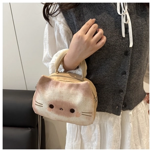 Detail of cute plush cat shaped handbag with soft fabric texture and sturdy handles