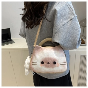 Détail du sac bandoulière chat avec pompon en peluche et lanière en cuir aux tons doux
