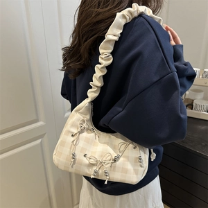 Beige plaid shoulder bag featuring cloud-like pleated straps and bow decorations