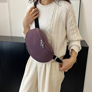 Purple nylon crescent chest bag with adjustable black strap and silver double zippers