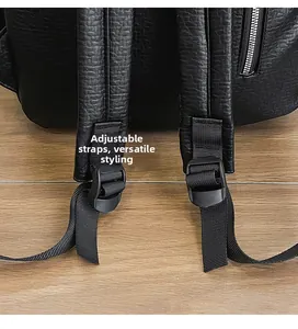 Detail of adjustable nylon strap and metal zipper on black textured leather backpack