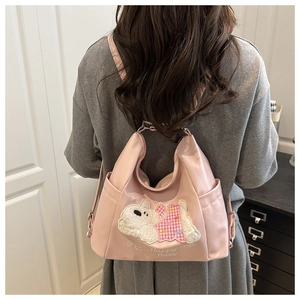 Pink waterproof nylon backpack featuring a cute puppy plush patch and embroidery