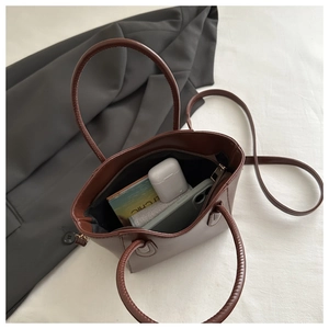 Top view of brown leather bucket bag showing interior space for phone and accessories