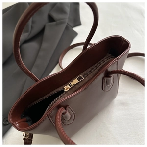 Overhead view of the dark brown leather handbag showing the zipper and spacious interior