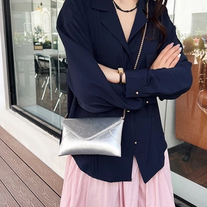 Silver metallic envelope crossbody bag with gold chain strap for stylish summer fashion