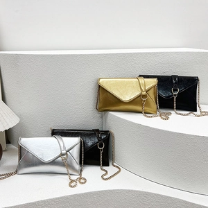 Three textured metallic envelope chain crossbody bags in silver, gold and black colors
