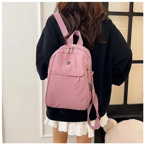 Detailed back view of a pink lightweight nylon backpack with multi-layer zipper pockets
