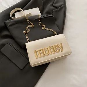 Size comparison of beige crossbody bag with gold money lettering and chain strap