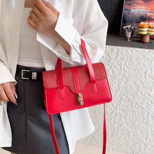 Elegant red shoulder bag with glitter flap and gold hardware for 2025 summer style