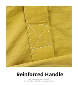 Detail of mustard yellow tote bag showing reinforced handle stitching for durability