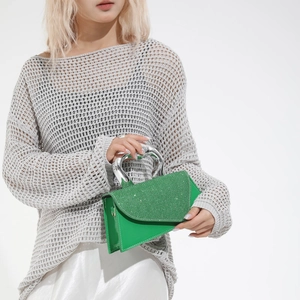 Chic lime green leather handbag with glitter flap and sculptural silver metal handle
