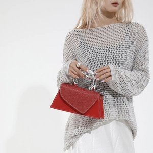Minimalist red trapezoid handbag with silver liquid metal handle and glitter finish
