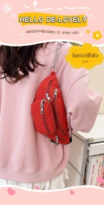 Macro detail of red nylon crossbody bag with metal chain on model wearing pink sweatshirt