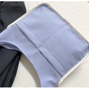 Detail view of the bag interior showing light blue lining with fine white stitching