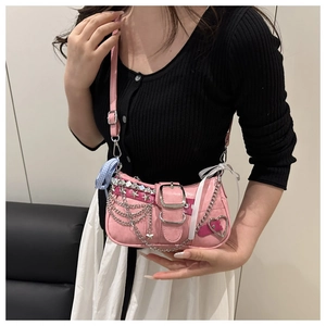 Pink Y2K shoulder bag with multi-layer silver chains and heart charms on model