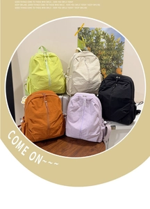 Detailed view of lightweight nylon backpacks in green, beige, black, orange, and purple hues