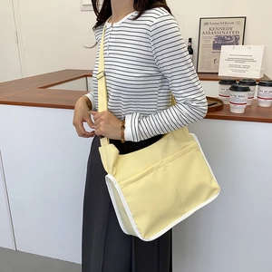 Minimalist light yellow crossbody bag with large capacity and adjustable shoulder strap