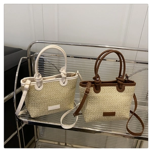 Detailed comparison of beige woven straw bucket bags in cream and caramel leather trims