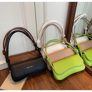 Detailed view of large PU leather crossbody bags in five colors with knotted shoulder straps