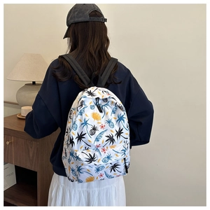 Detail view of large white canvas backpack with tropical palm tree and pineapple print