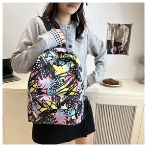 Detail shot of the durable graffiti print backpack with colorful artistic patterns