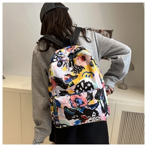 Detail of colorful graffiti print and front zipper pocket on a stylish fashion backpack