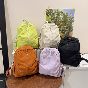 Minimalist nylon travel backpacks in five colors including neon green and purple