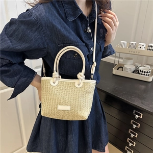 Pastel straw bucket bag with white leather trim and dual handles for summer style