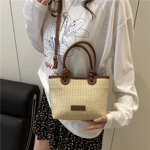 Pastoral straw bucket bag with brown leather trim and knot handle for summer travel