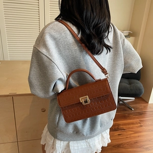 Brown crocodile texture square handbag worn over the shoulder with gold buckle