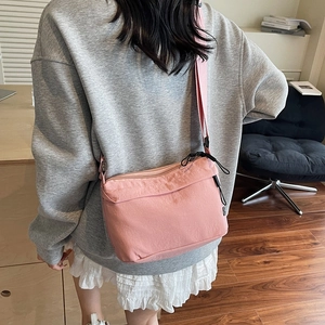 Minimalist pink nylon messenger bag for women with adjustable strap for daily travel use
