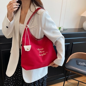 Large red canvas tote bag with gold lettering and white mini pouch for daily commute