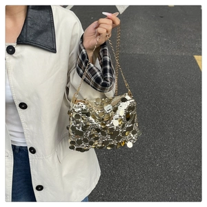 Detail of a sparkling sequin chain bag with gold and silver metallic round discs