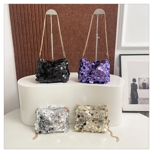 Detailed shot of four sequined crossbody bags in black, purple, silver, and champagne gold