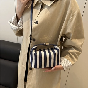 Women striped canvas shoulder bag with blue vertical stripes and metal clasp