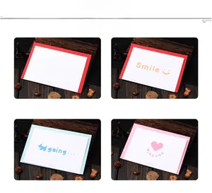 Detail of colorful hollow greeting cards with envelopes on a rustic wooden desk